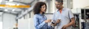 Male and female electrical engineers discussing products