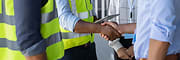 Men on construction site shaking hands
